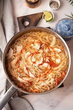 a pan filled with noodles and sauce on top of a table