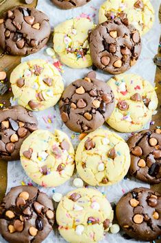 chocolate chip cookies with sprinkles and confetti are on a baking sheet