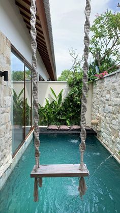 a pool with a swing hanging from it