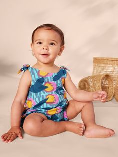 From our Kenya collection, this adorable printed romper is made of super lightweight and breathable 100% soft cotton jersey that will keep its color and shape, wash after wash. Features adjustable shoulder ties, inseam snaps, and elastic leg openings for easy dressing and diaper changes. Falls at mid-thigh. Playful Printed Sleeveless Jumpsuits And Rompers, Summer Cotton Bubble Romper For Loungewear, Printed Summer Bodysuit For Loungewear, Casual Printed Bubble Romper For The Beach, Summer Printed Bodysuit For Loungewear, Summer Printed Loungewear Bodysuit, Playful Cotton Jumpsuits And Rompers For Playtime, Summer Cotton Printed Bubble Romper, Printed Cotton Onesie For Playwear