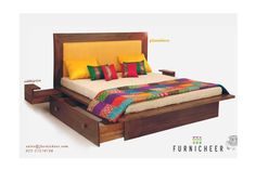 a bed with two drawers underneath it and colorful pillows on the headboard, in front of a white background