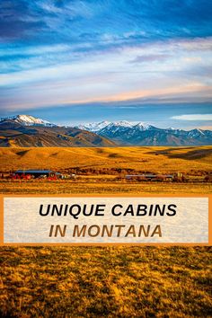 a sign that says unique cabins in montana on the side of a road with mountains in the background