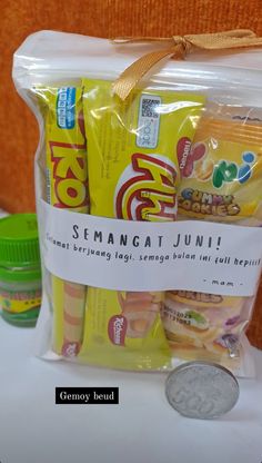 a bag of snacks sitting on top of a table next to a coin