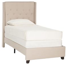 a white bed with a beige headboard and pillows on it's sides, against a white background