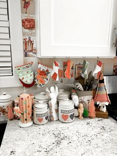 the kitchen counter is covered with dishes and knick - knacks for cooking