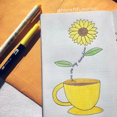 a drawing of a coffee cup with a sunflower on it