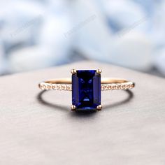 an engagement ring with a blue stone surrounded by diamonds