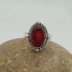 Red onyx Gemstone 925 silver ring with stylish design for your daily wearing accessories. This red onyx also know as red stone boho ring can make your daily fashion goals more interesting  and trendy. The red onyx symbolizes soothing in stress and nervousness help you in increase sing  physical strength. If you searching for something that gives your fashion style extra wing and helps you in health benefits than this stone ring is for you. This can be the perfect gift for your loved ones, family and friends.  Rings Details  Metal: 925 Sterling Silver Gemstone : red onyx  Gemstone Shape: Oval SKU : Ring45 Ring Size : All Size Available For more new arrivals  and discount please favorite our shop Elegant Red Rings With Natural Stones, Red Sterling Silver Rings With Natural Stones, Red Sterling Silver Ring With Natural Stones, Handmade Carnelian Ring, Red Sterling Silver Oval Cabochon Ring, Onyx Rings, Red Band, Onyx Gemstone, Women Ring