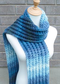 "This beautiful hand knitted scarf is made with Soft  100% Acrylic Yarn. Classic ribbed pattern. The scarf can be worn in multiple ways. Very beautiful colors: shades of blue, teal, and grey green. The colors may appear slightly different on different monitors. Measures: 67\" (170 cm) long x 6.5\" (17 cm) wide. From a smoke-free home. Care instructions: Hand wash in cool water and dry flat." Blue Knitted Scarves For Winter, Blue Knitted Winter Scarves, Blue Knitted Yarn Scarves, Blue Knitted Yarn Scarf, Blue Yarn Knitting Pattern For Winter, Winter Blue Yarn Knitting Pattern, Winter Knitting Pattern In Blue Yarn, Blue Knitted Scarf, One Size, Blue Knitted Scarf One Size