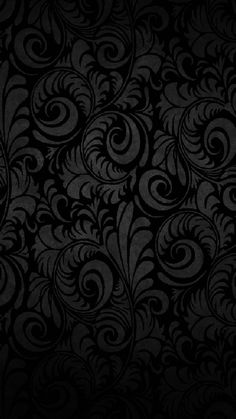 an abstract black background with swirls and leaves