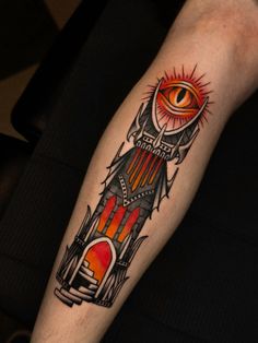 a man's arm with an eye on it and a rocket ship in the background