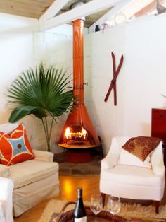 a living room filled with furniture and a fire place in the middle of the room