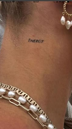 a woman with a tattoo on her neck and the word energy written in small letters