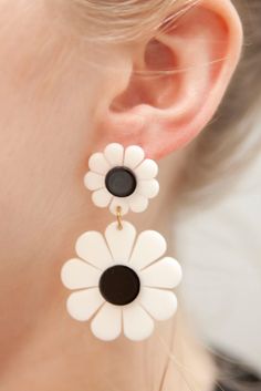 a pair of white and black flower earrings