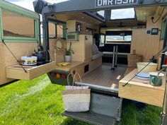 the inside of a camper with its door open and shelves full of items on it