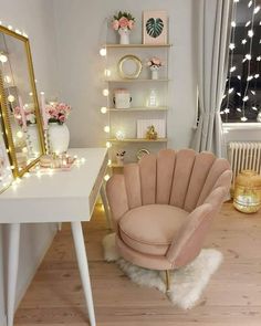 a white desk with a chair, mirror and lights in the corner next to it