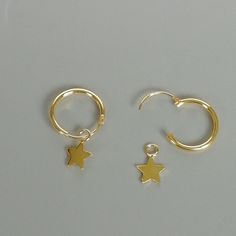 A PAIR of sterling silver hoops dipped in gold. Comes with a tiny star charm. The charm is multipurpose and can be used with a neck or bracelet chain too. Dimension: Hoop- 12x1 mm Charm- 5x5 mm Drop length- 18mm Price listed is for ONE PAIR These are made of 925 hypoallergenic sterling silver plated in gold. Most of my pieces come with a 925 stamp. Can be packaged in a gift box. I can include a personal message from you if needed You are welcome to contact me at... bhavnakwintra1956@gmail.com Fo Celestial Small Hoop Earrings With Star Charm, Celestial Hoop Earrings With Star Charm For Everyday, Minimalist Dangle Hoop Earrings With Star Charm, Everyday Small Hoop Earrings With Star Charm, Dainty Star-shaped Hoop Earrings For Everyday, Minimalist Star Charm Huggie Earrings, Minimalist Huggie Earrings With Star Charm, Minimalist Gold Hoop Earrings With Star Charm, Dainty Hoop Earrings With Star Charm