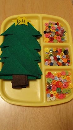 a yellow tray with buttons and a green christmas tree on it