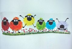 a group of sheep are painted on the side of a white paper sheet with grass and flowers