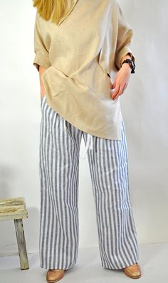 "Natural Linen White pants. Summer Loose Drop crotch Pants. Loose asymmetric linen pants. Every day comfortable pants. Maxi trousers. Cool casual pants. Striped 100% lINEN pants. Comfortable and Relaxed. Zipped pants. The style I used was originally designed and professionally constructed by me. Each item of my shop has a special package. Handmade in a pet-free and smoke- free environment. Model on picture is wearing size S Size chart Gabyga: XS (US 2, UK 6) Bust: around 33.5\" / 85 cm Waist: ar Casual Linen Harem Pants For Vacation, Baggy Linen Bottoms For Vacation, Beach Linen Harem Pants With Pockets, Beach Harem Pants With Pockets In Linen, Baggy Linen Beach Pants, Flax Linen Beach Bottoms, Bohemian Linen Bottoms With Pockets, Beach Linen Pants In Flax Color, Beach Cotton Bottoms In Flax Color