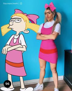 a woman standing next to a cartoon character