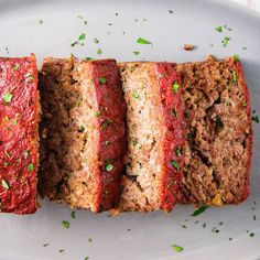 sliced meatloaf on a white plate with parsley sprinkled on top