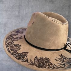 Burned Wide Brim Hat in Taupe Wide Brim Burned Hat using Pyrography techniques. Each hat is burned freehand. No Stencil, therefore each hat is a one of a kind. Each Hat is sealed with a weather proofer, good for up to 12 months. Hats made by PIPER also comes with a signature travel bag and handmade macrame Wall Hanger. Black Burned Hat, Hat Pyrography, Custom Hat Ideas, Pyrography Techniques, Custom Fedora, Burned Hats, Painting Clothes, Hat Burning, Macrame Wall Hanger