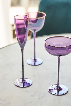 A sleek, etched stem supports the Alta Collection, made even more glamorous by its striking gold rim and chrome finish. The glass of celebrations and festivities, the elongated flute lets sparkling wines and bubbling champagnes fizz with delight before a cheerful toast. | Alta Flute Glasses, Set of 4 by Anthropologie in Purple, Size: S/4 flute Dinner Party Drinks, Modern Wine Glasses, Flute Glasses, Glass Photography, Dinner At Home, Wedding Glasses, Outdoor Holiday Decor, Party Drinks, Casual Dinner