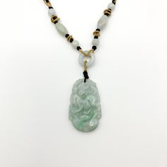 This is a high grade jadeite jade pendant necklace. It is exquisitely hand carved, so each pendant is different in some way. The pendant is completely natural jade, un-dyed and in its natural form. The pendant is carved in the form of the Chinese Zodiac - Dog. The beads above the pendant on the necklace are natural hand carved jadeite jade beads. They may not be perfectly round because they are hand carved. This gives the necklace a more rustic and natural stone like look. The years of the Dog i Oval Carved Jade Jewelry, Jade Amulet Pendant Necklace, Carved Oval Jade Jewelry, Carved Jade Round Bead Necklaces, Carved Jade Jewelry For Good Luck, Hand-strung Jade Necklaces With Round Beads, Dog Chinese Zodiac, Engraved Jade Amulet Jewelry, Red Pendant Necklace