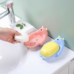 a person is holding a soap dispenser in front of a sink