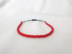 RED Beaded Minimal Cord Bracelet * Size 6-7 Inches * Opaque Red Bead Bracelet * Red Seed Bead Bracelet * RED String Bracelet * Red Bracelet This is a minimal bracelet, A lightweight & delicate bracelet and perfect for everyday wear.  Perfect as Birthday, Christmas and Friendship presents. The bracelet will fit wrist size 6 to 7 inches. Please note this bracelet is not sterling silver.  If you have any questions about the bracelet, contact me through the "Etsy conversation system". PLEASE NOTE: C Red Adjustable Friendship Bracelets With Tiny Beads, Adjustable Red Friendship Bracelets With Tiny Beads, Red Beaded Bracelets With Spacer Beads As Gift, Adjustable Red Friendship Bracelets With Spacer Beads, Adjustable Red Friendship Bracelets With Colorful Beads, Adjustable Red Friendship Bracelets, Red Bracelets With Tiny Beads As Gift, Red Friendship Bracelets With Sliding Knot, Adjustable Red Hand-strung Bracelet