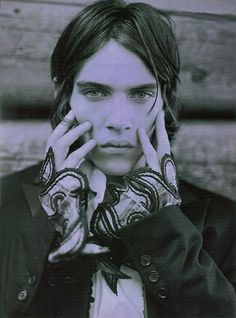 black and white photograph of a woman with her hands to her face, wearing a suit