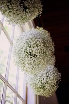 the flowers are hanging from the ceiling in front of the window sill and stairs