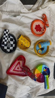 several colorful objects are laying on a white sheet