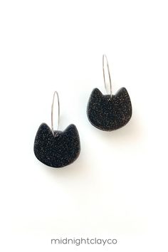 Black glitter polymer clay earrings. Cat shaped dangle earrings with gold earring hoops. Cute cat lover earrings make the perfect accessory for any outfit. Give as a unique birthday gift for daughter, teen girl, or mother in law or crazy cat lady. Makes a great summer birthday gift! Shop these trendy handmade earrings for women in my etsy shop! Adjustable Cat Ears Earrings As Gift, Nickel-free Cat Ears Jewelry For Gifts, Nickel-free Cat Ears Jewelry Gift, Adjustable Cat Ears Earrings For Gift, Hypoallergenic Cat Ears Earrings For Gift, Hypoallergenic Cat Ears Jewelry For Gift, Sterling Silver Cat Ears Earrings, Sterling Silver Cat Ears Earrings Gift, Nickel-free Cat Ears Earrings As Gift