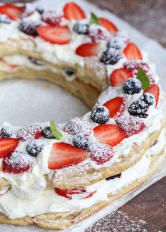 a cake with strawberries and powdered sugar on top