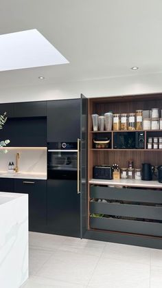 a kitchen with black cabinets and white counter tops