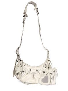 Find BALENCIAGA Le Cagole Leather Shoulder Bag on Editorialist. The BALENCIAGA Le Cagole Leather Shoulder Bag features a top zip closure, adjustable strap, silver-toned metal hardware, and includes a detachable mirror and zip pouch. The bag measures 16cm in height, 25.9cm in width, and 6.8cm in depth. The minimum strap length is 22cm, the maximum strap length is 51cm, and the strap drop is 47cm. The bag can be worn on the shoulder or crossbody. Balenciaga Women, Vintage Effect, Balenciaga Bag, Strap Top, Zip Pouch, Strap Tops, Metal Hardware, Silver Color, Leather Shoulder Bag