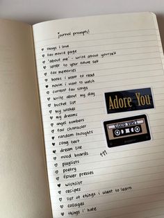 an open notebook with stickers on it that say adore you and tape recorders