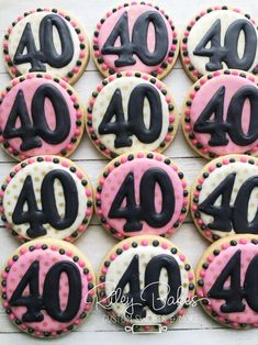 decorated cookies with black and pink icing are arranged in the shape of forty forty