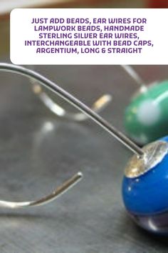 a blue and green object sitting on top of a metal table next to a pair of scissors