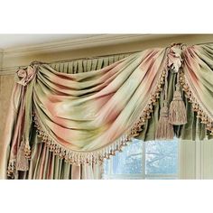 a window curtain with tassels hanging from it