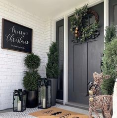 the front door is decorated for christmas with wreaths and decorations