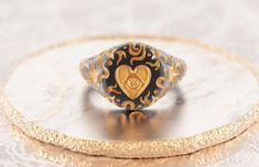 Meaningful signet for her, which translates wish making and life. Black and gold design, silky satin finish with warm golden details -925 Silver -Black rhodium&gold plating -Weight~7 gm Please allow up to 2-3 weeks for production, as each item is made to order. Black And Gold Design, Dark Grey Background, Ring Heart, Jewelry Aesthetic, Signet Rings, Black Rhodium, Pinky Ring, Sacred Heart, Gold Design