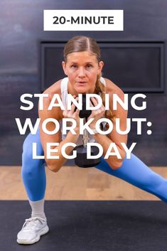 a woman in blue leggings and white shirt doing a plank on the floor