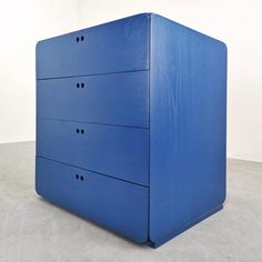 a blue chest of drawers sitting on top of a floor