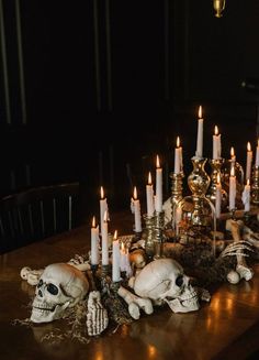 a table topped with lots of candles and skulls