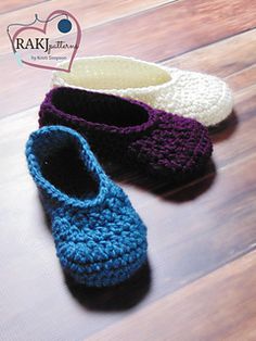 three crocheted slippers sitting on top of a wooden floor next to each other