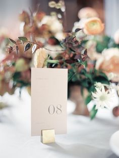 an elegant table setting with flowers and place cards