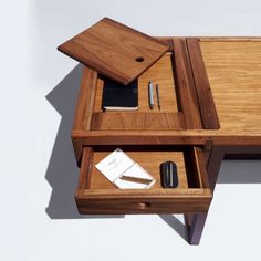 a wooden desk with two drawers and a pen holder on it's left side